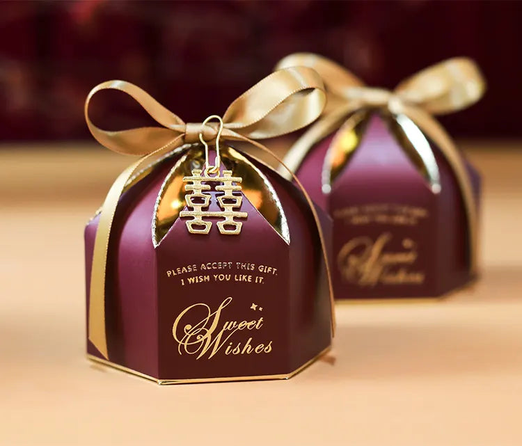 Elegant Wedding Favor Boxes with Double Happiness Charm  with gold ribbon and 'Sweet Wishes' text on a beige background