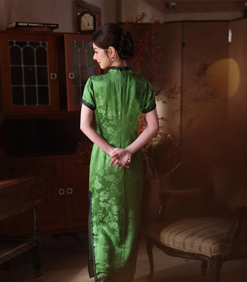 Woman wearing a Emerald Forest Green Silk-Blend Qipao with Lace Trim traditional dress in an indoor setting