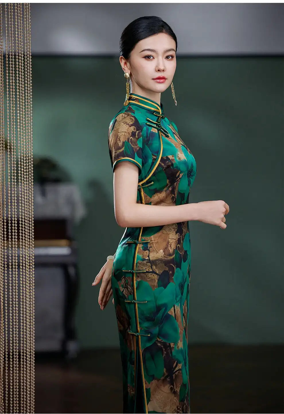 Woman wearing aEmerald Green Floral Silk Chinese Qipao Cheongsam Dress   with a blurred background