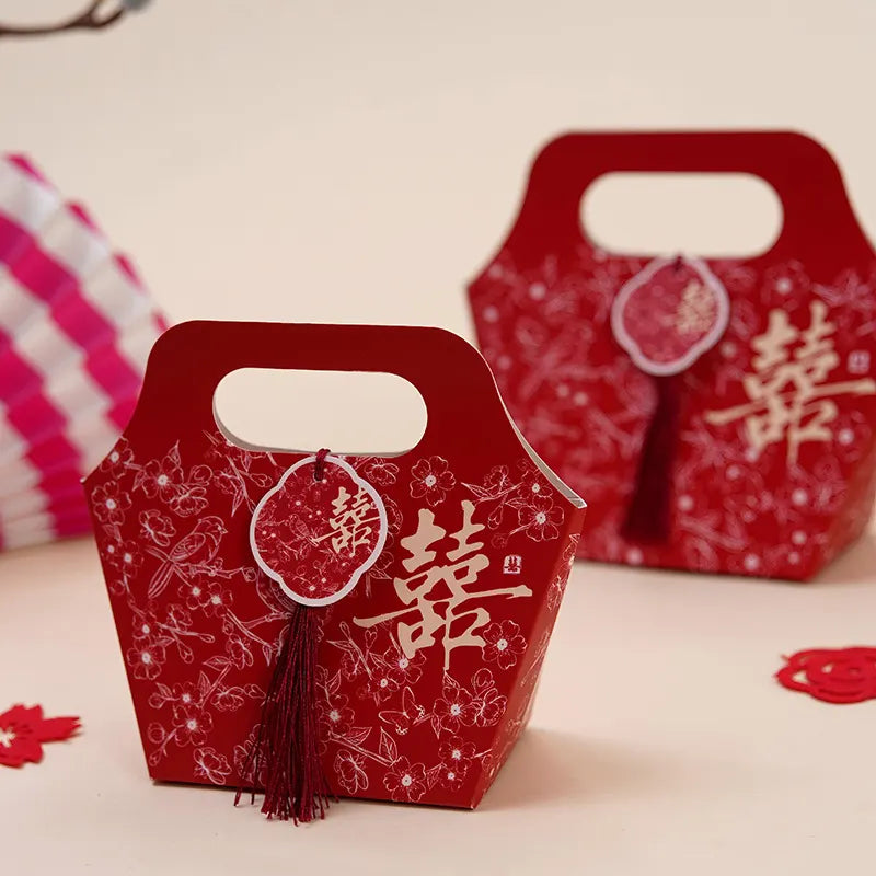 red Floral Chinese Wedding Favor Boxes with Double Happiness Tassel  with Chinese characters on a light background