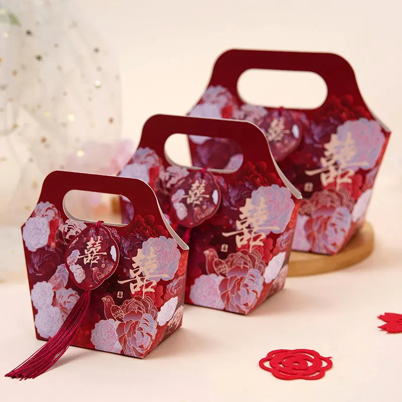 Red Floral Chinese Wedding Favor Boxes with Double Happiness Tassels and Chinese characters on a light background