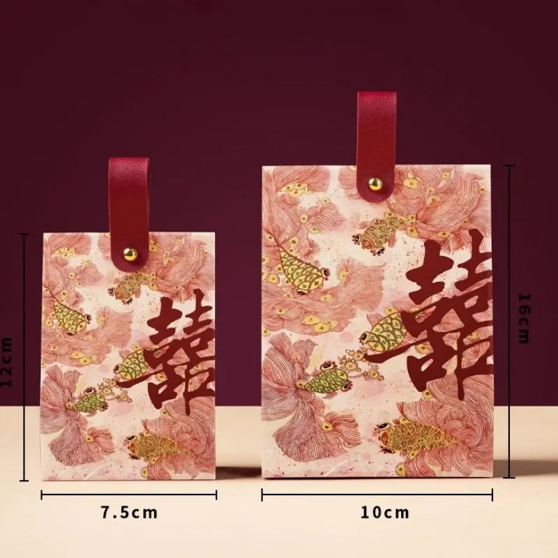 Two Floral & Koi Fish Double Happiness Wedding Favor Boxes With Handle with red leather loops and gold hardware, shown with printed floral and butterfly designs and Chinese double-happiness symbols. Measurement labels indicate 12 cm height by 7.