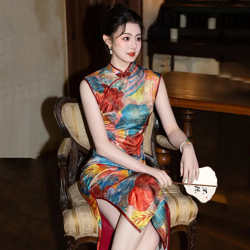 Woman in a colorful Floral Sleeveless Traditional Chinese Qipao Cheongsam Dress sitting on a chair in a dimly lit room.