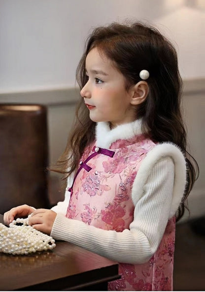 A child girl in winter pink quilted vest cheongsam dress