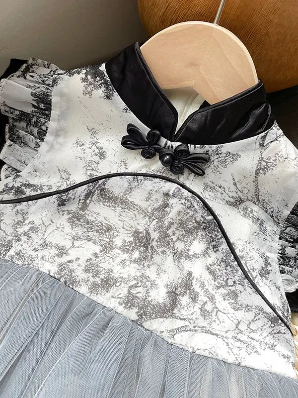 A close-up of a Girls Traditional Ink Painting Sleeveless Layered Tulle Qipao Dress , paired with a light gray tulle skirt.
