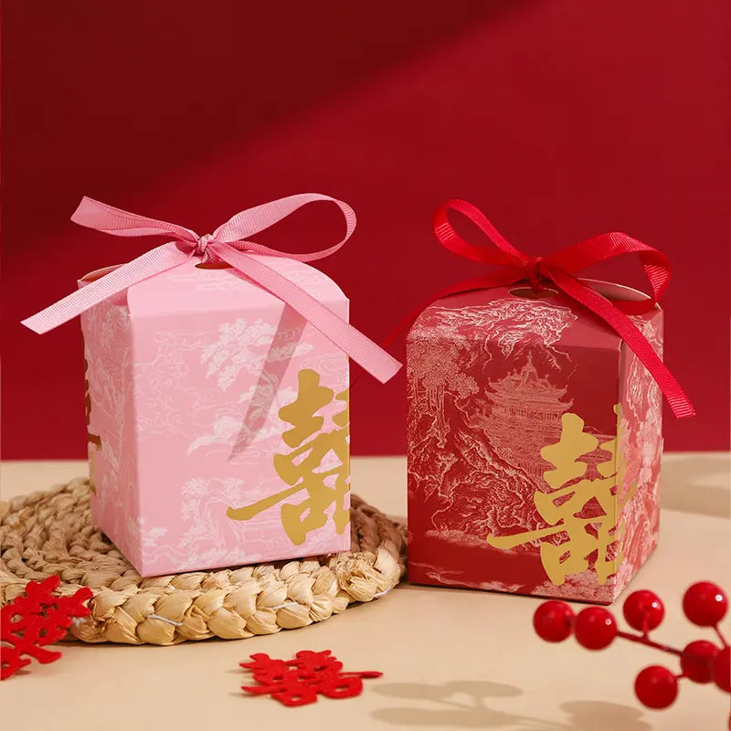 Two Gold Foil Double Happiness Chinoiserie Wedding Favor Boxes  with ribbons on a red background