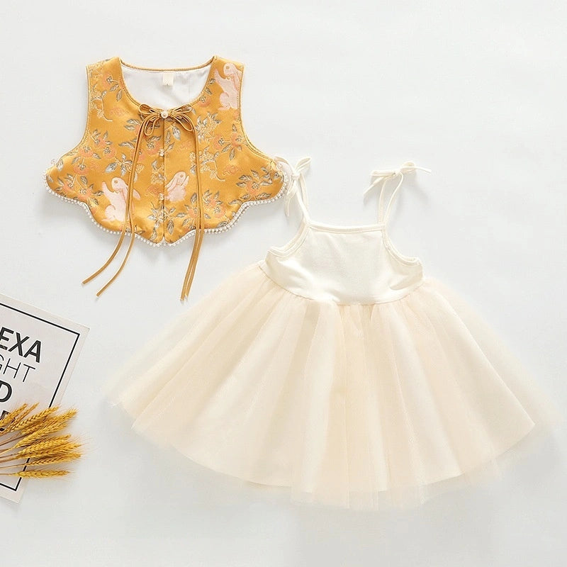 A baby girl's  Golden Brocade Vest & Tulle Chinese Baby Princess Dress   outfit laid flat on a white background, featuring a mustard yellow embroidered vest with a bow and a cream tulle tutu dress with tie straps.