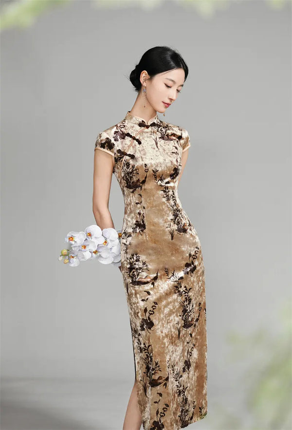 Woman wearing a long, Golden Floral Velvet Qipao Cheongsam Dress against a gray background