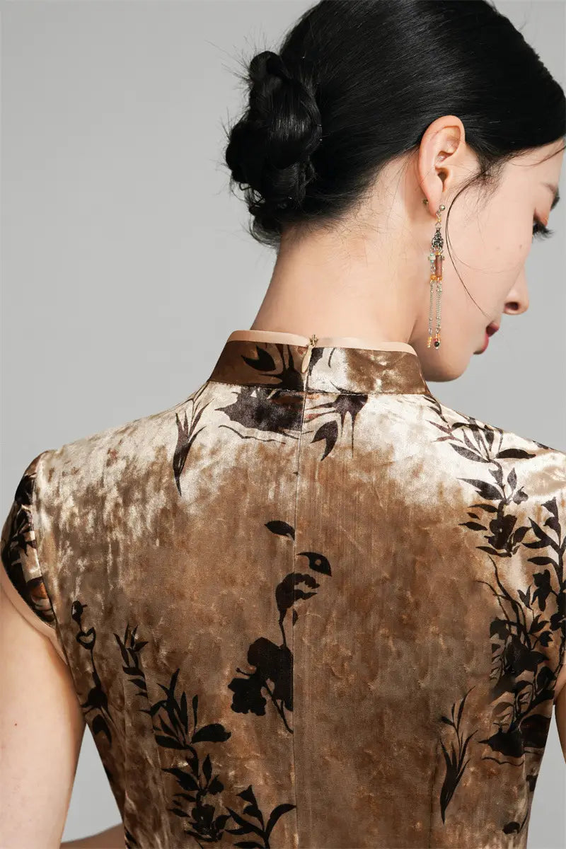 Woman wearing a Golden Floral Velvet Qipao Cheongsam Dress with a plain background