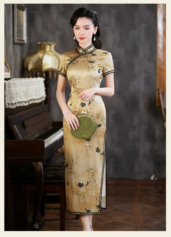 Woman in a traditional Golden Mulberry Silk Qipao Dress with Black Floral Print  standing in a room with a piano.