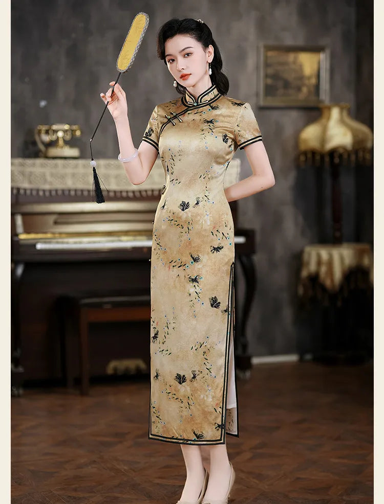 Woman in a traditional Golden Mulberry Silk Qi pao cheongsam Dress with Black Floral Print  holding a broom in an elegant interior setting