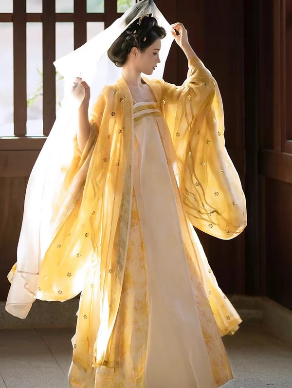 Person wearing a Golden Traditional Chinese Tang Dynasty Hanfu Dress Set garment with flowing sleeves indoors.