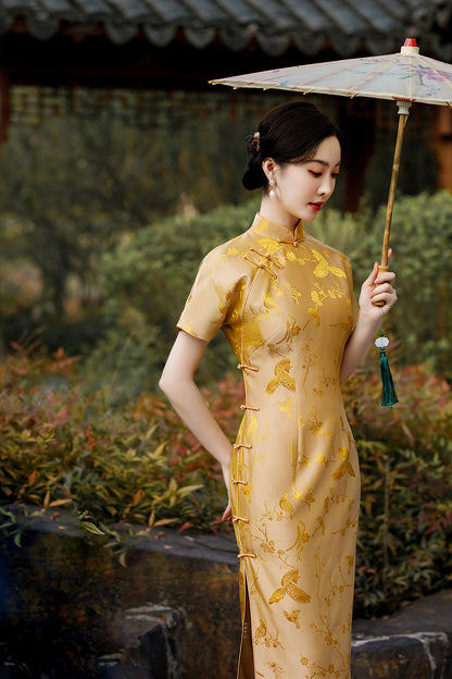 A chinese girl in gold silk  cheongsam with  intricate floral and bird jacquard patterns