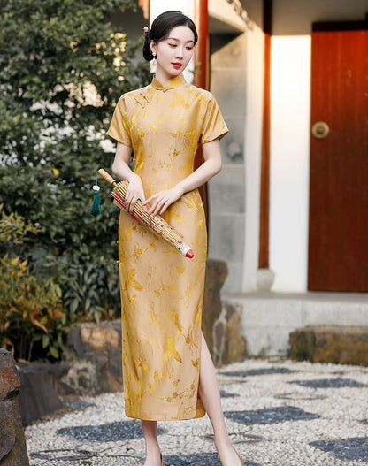 A chinese girl in gold silk qipao  with  intricate floral and bird jacquard patterns with umbrella on hand