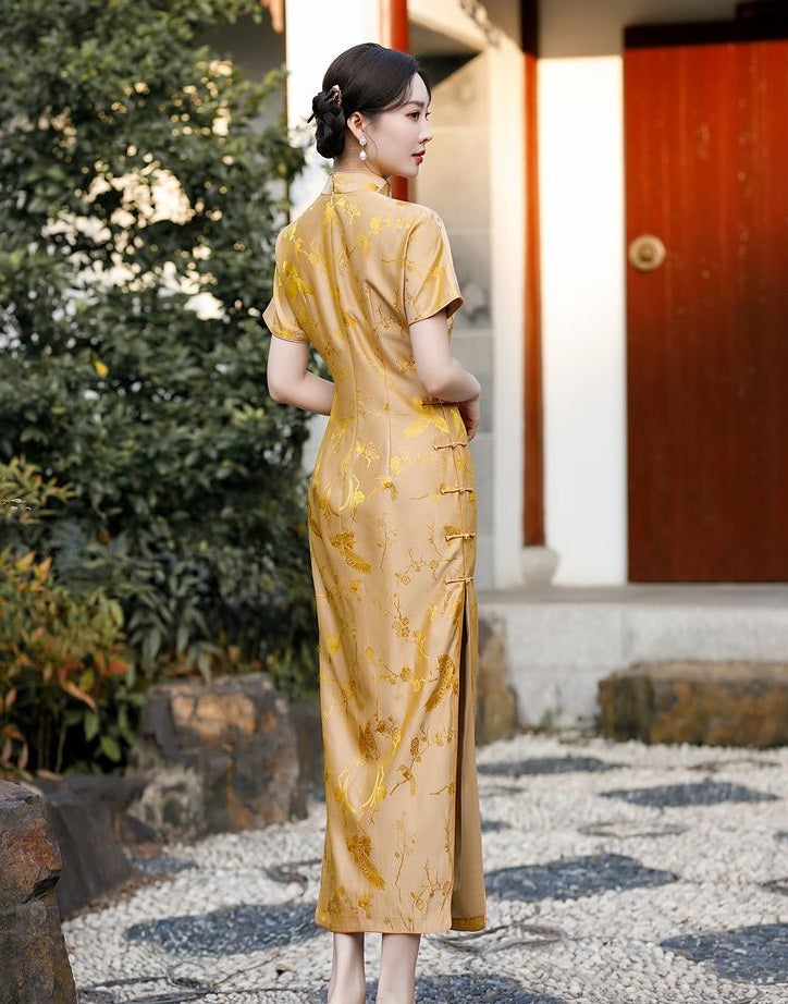 A chinese girl in gold silk qipao  with  intricate floral and bird jacquard patterns back