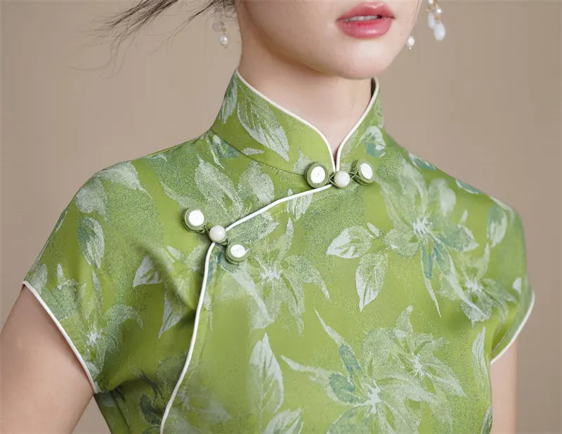 Green floral dress with white buttons on a neutral background