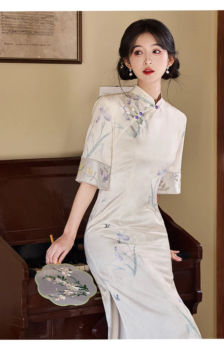 Woman in a traditional Chinese dress with floral patterns in an indoor setting.