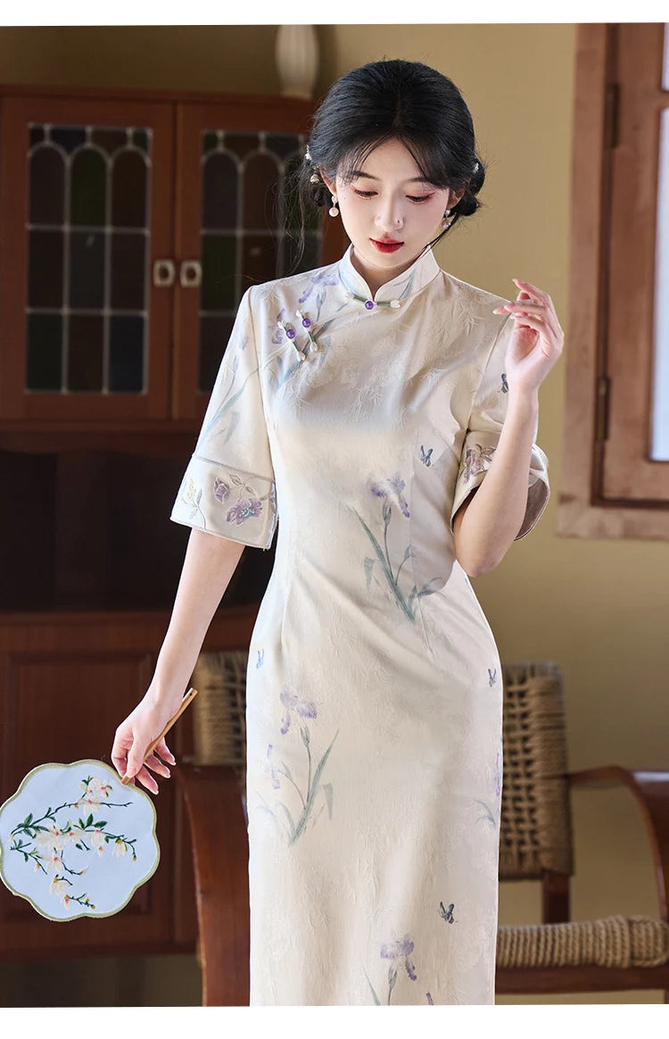 Woman wearing a traditional Chinese Ivory Floral Jacquard Qipao Dress with Embroidery  in a room with wooden furniture.