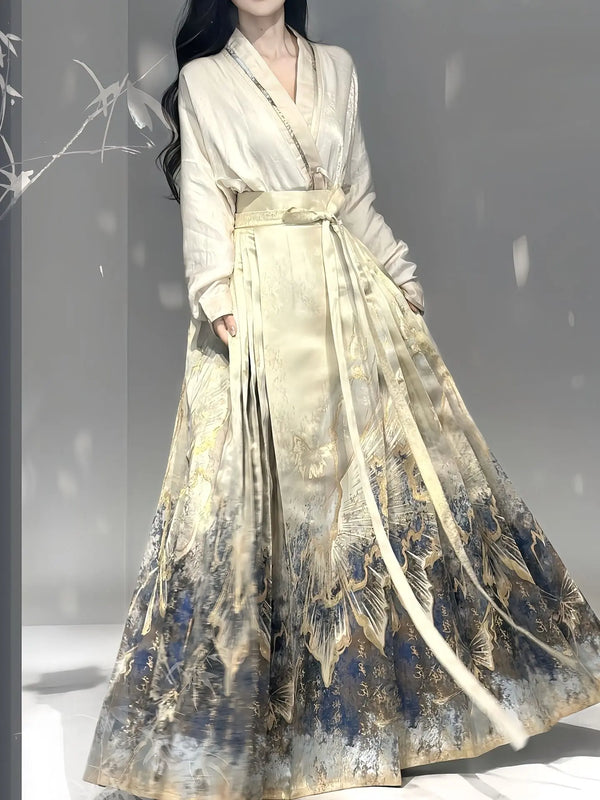 A woman wearing a traditional Chinese Hanfu dress with a cream-colored long-sleeve top and a wide, pleated chinese ming dynasty mamian horse face skirt featuring a blue and gold landscape print.
