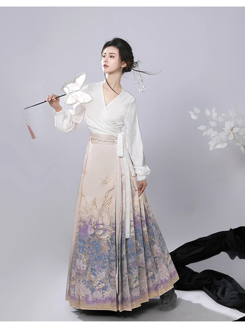 Woman in traditional Chinese ming dynasty Jacquard Brocade Gold Woven Floral Hanfu Mamian Skirt attire with a white top and patterned skirt on a light gray background