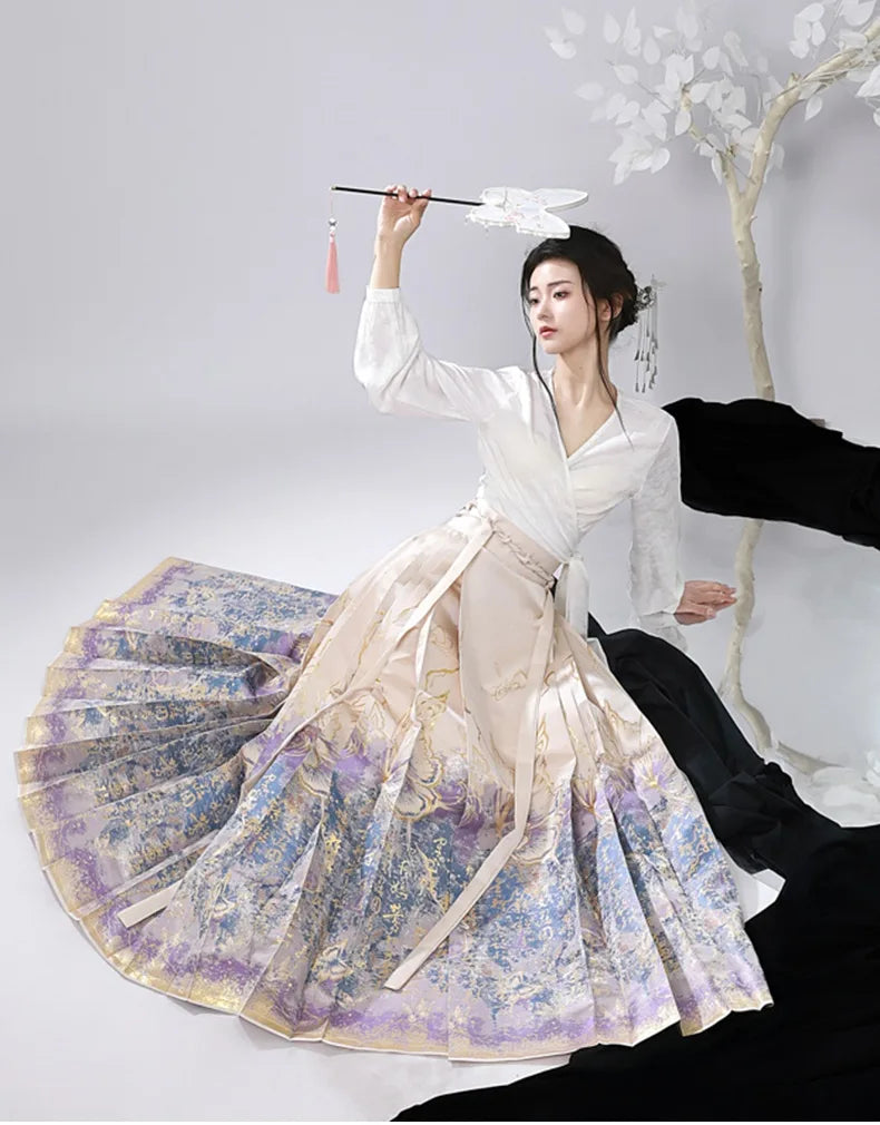Woman in traditional Jacquard Brocade Gold Woven Floral Hanfu Mamian Skirt attire with a fan, standing against a plain background