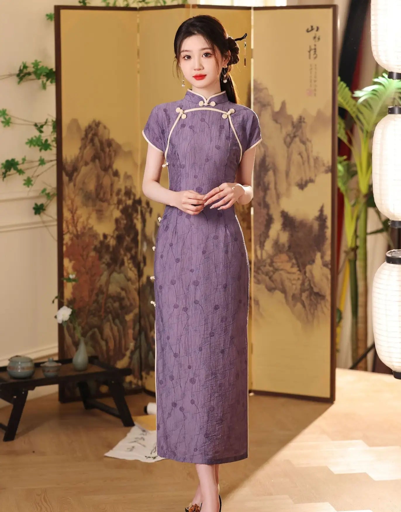 Woman in a traditional purple Lavender Floral Short Sleeves Jacquard Qipao Dress standing in a room with a decorative screen and lanterns.