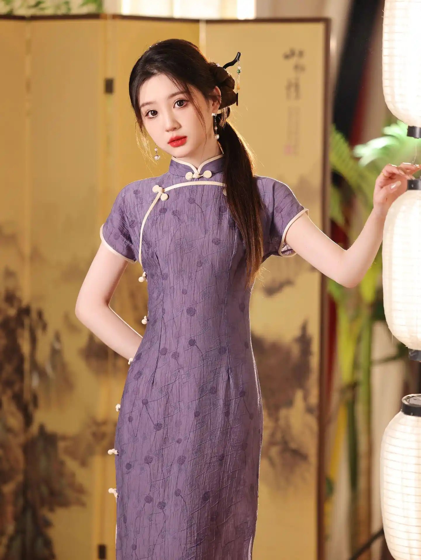Woman in a purple Lavender Floral Short Sleeves Jacquard Qipao Dress traditional  dress holding a white lantern indoors.