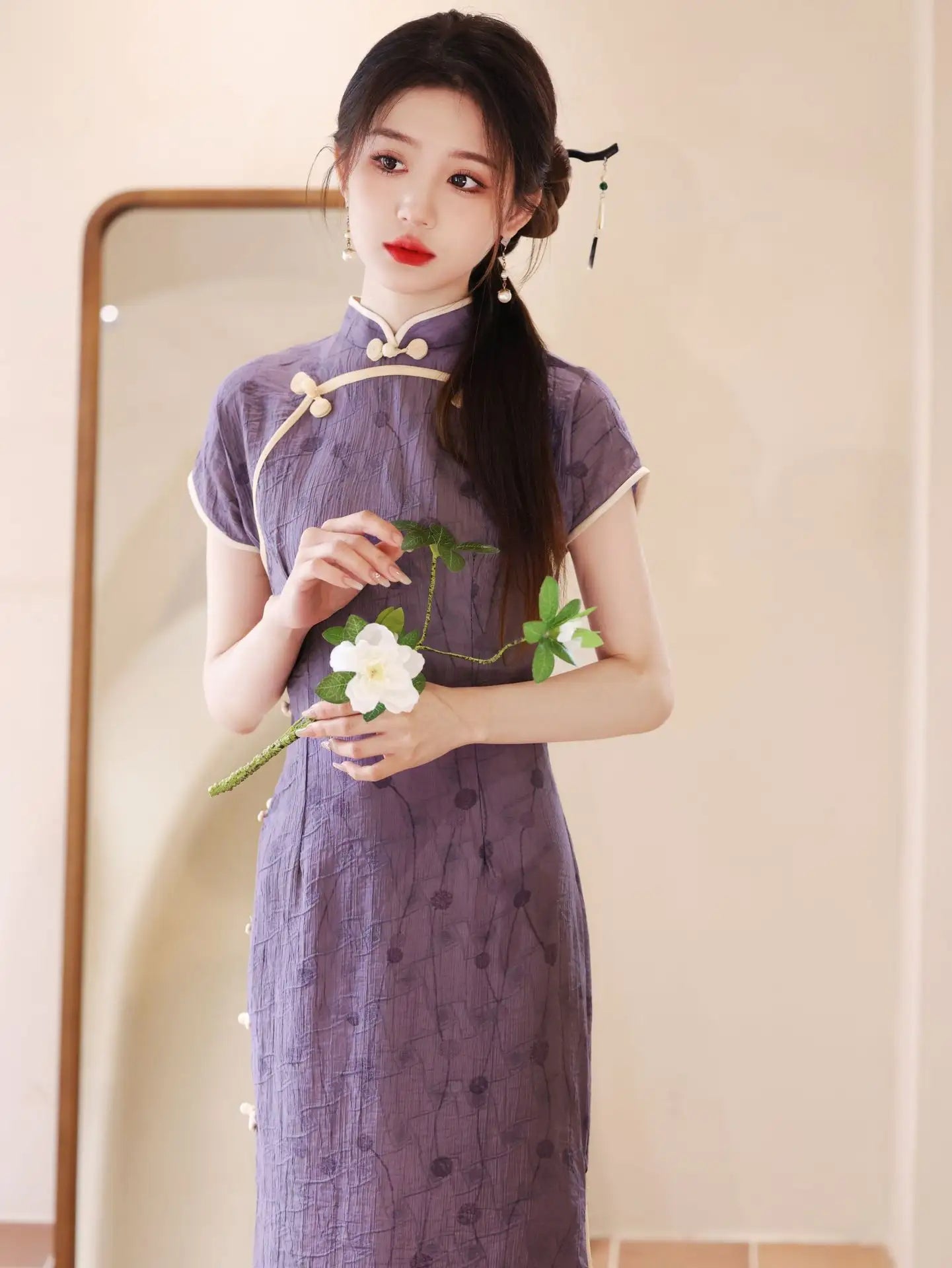 Woman in a traditional purple Lavender Floral Short Sleeves Jacquard Qipao cheongsamDress holding a white flower in front of a mirror.