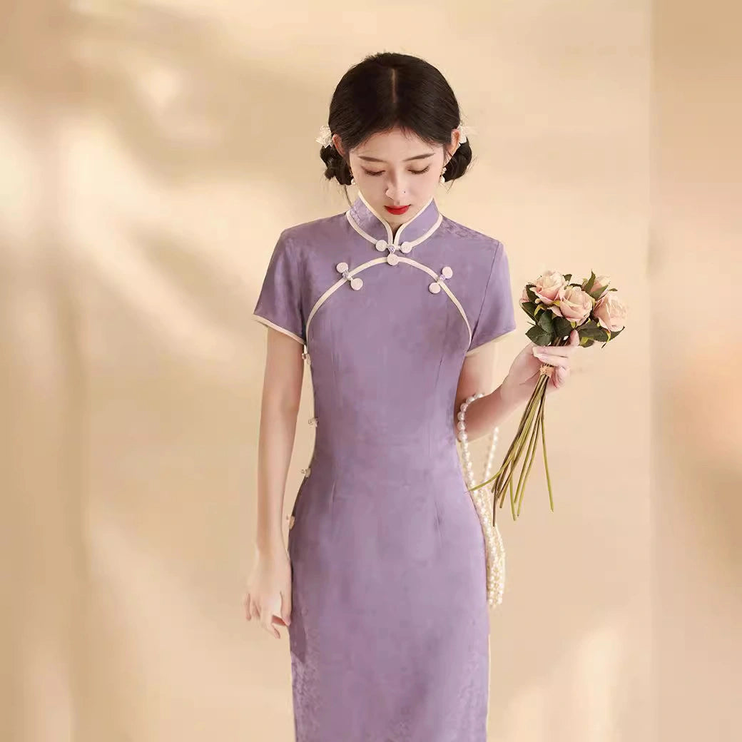 Woman in a purple Lavender Floral Short Sleeves Jacquard Qipao Dress holding flowers against a beige background