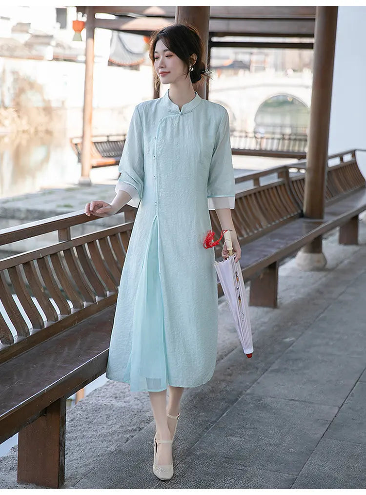 Woman in a Light Green Loose A Line Cheongsam Qipao Dress standing by wooden benches outdoors