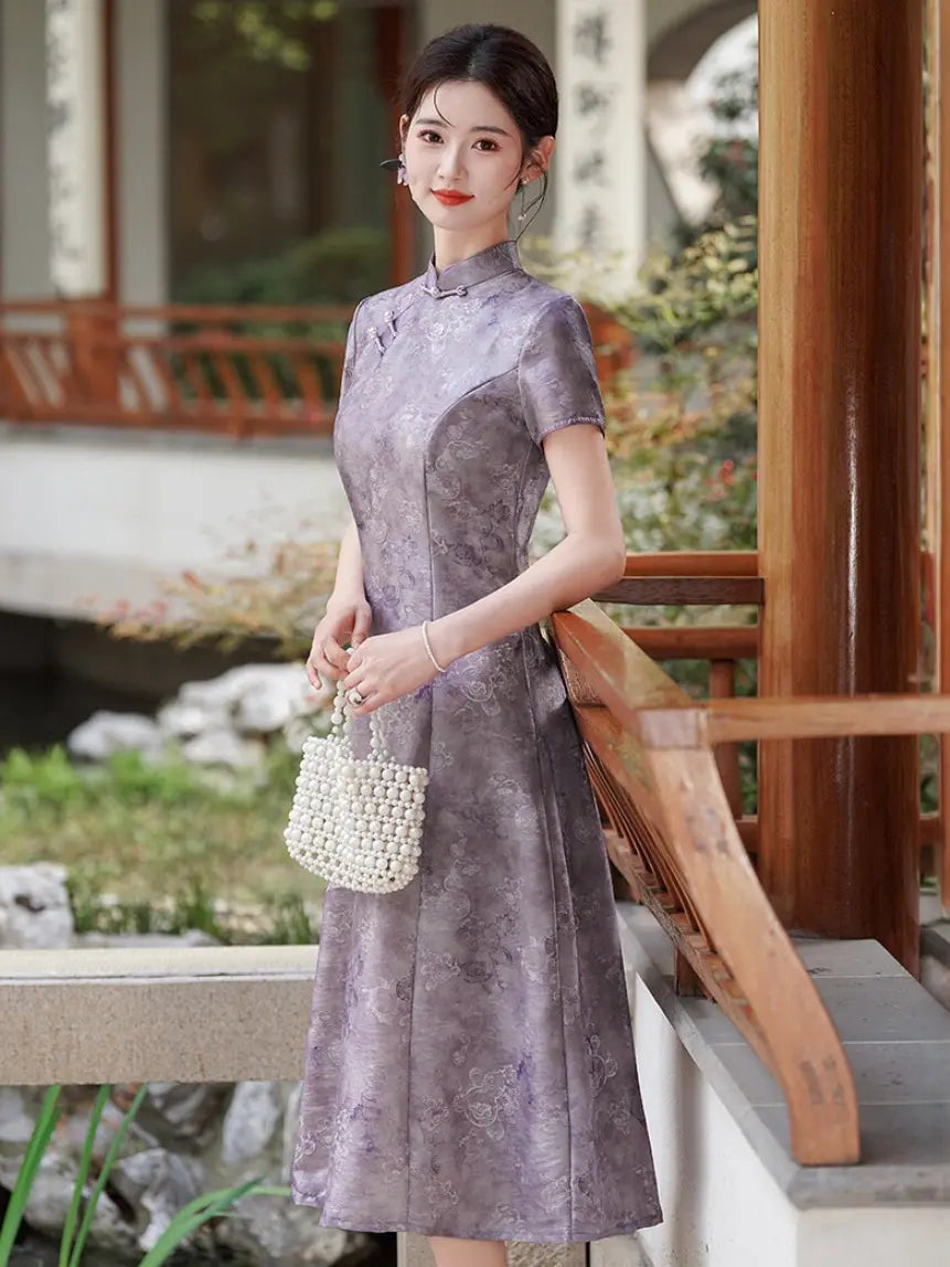 A woman wearing a short-sleeve Lilac Purple Floral Jacquard Modern A Line Qipao  cheongsam dress with a subtle floral jacquard pattern, standing in a traditional garden courtyard next to a wooden railing.