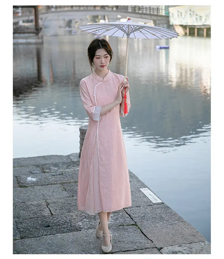 Woman in a pink Loose A Line Cheongsam Qipao Dress  holding an umbrella by a waterfront