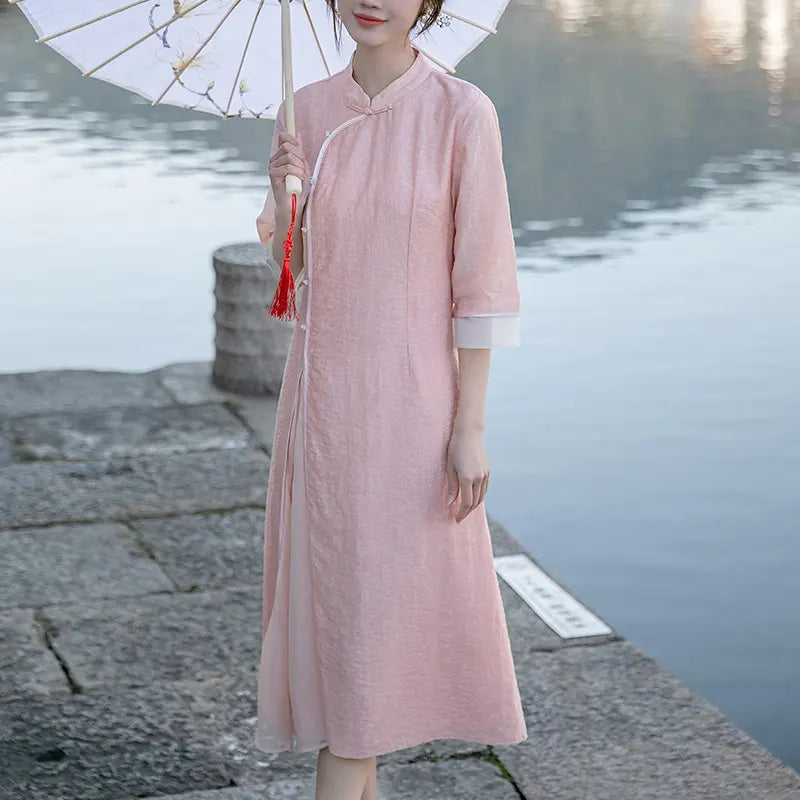 Woman in a pink Loose A Line Cheongsam Qipao Dress holding an umbrella by a body of water