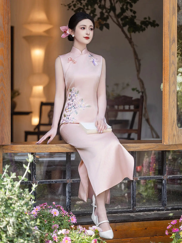 Woman in a traditional  Luxury Embroidered New Chinese Style Sleeveless Qipao Dress outfit sitting on a wooden bench with flowers and plants around.
