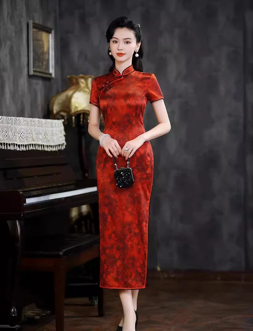 Woman in a Luxury Red Silk Qipao Dress with Maple Leaves Print  standing in front of a piano with a dark background
