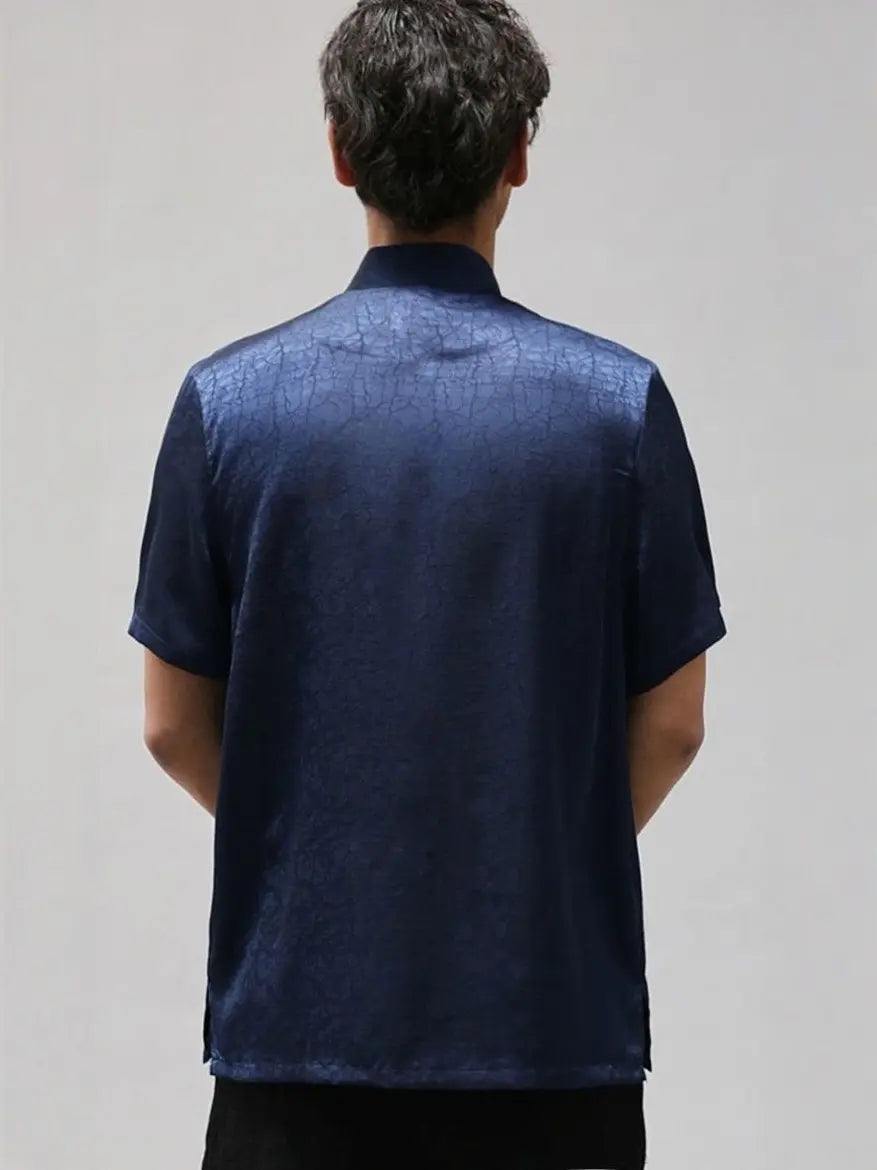 Person wearing a dark blue Men's Luxury Mulberry Silk Jacquard Short Sleeve Tang Shirt against a plain background