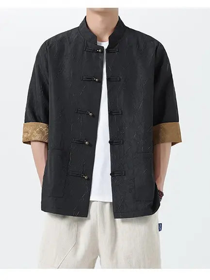 Person wearing a black traditional Men's Retro Crinkle Texture Half Sleeve Tang Suit Summer Shirt  with brown cuffs on a white background
