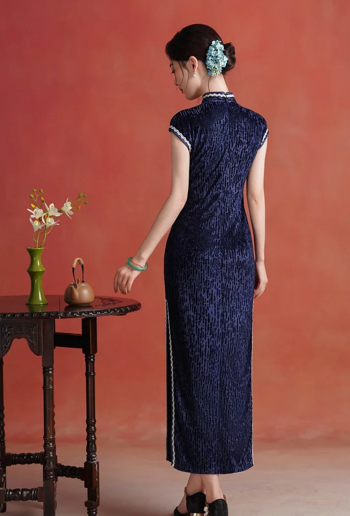 Woman in a Midnight Navy Blue Sleeveless Velvet Long  Qipao 2  dress standing against a red background