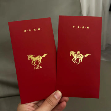 Two red envelopes with gold horse designs and text Minimalist 2026 Year of the Horse Red Envelopes - Lucky Money Packets , held by a hand against a neutral background.