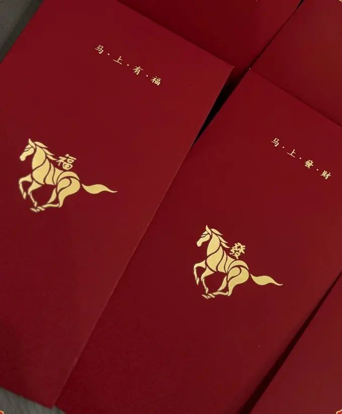 Red envelopes with gold horse illustrations and Chinese text on a red background