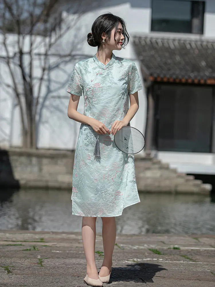 Woman in a light Mint Green Scenic Brocade Loose A Line Qipao Dress standing outdoors with a blurred background