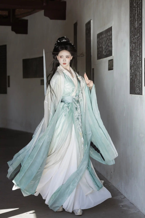 Person wearing traditional Chinese attire Mint Green Wei-Jin Dynasty Flowing Robe Hanfu Dress in a minimalistic indoor setting