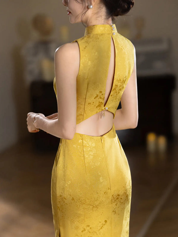 Woman wearing a yellow Modern Imperial Gold Open Back Jacquard Qipao Dress evening gown with a cut-out back design.