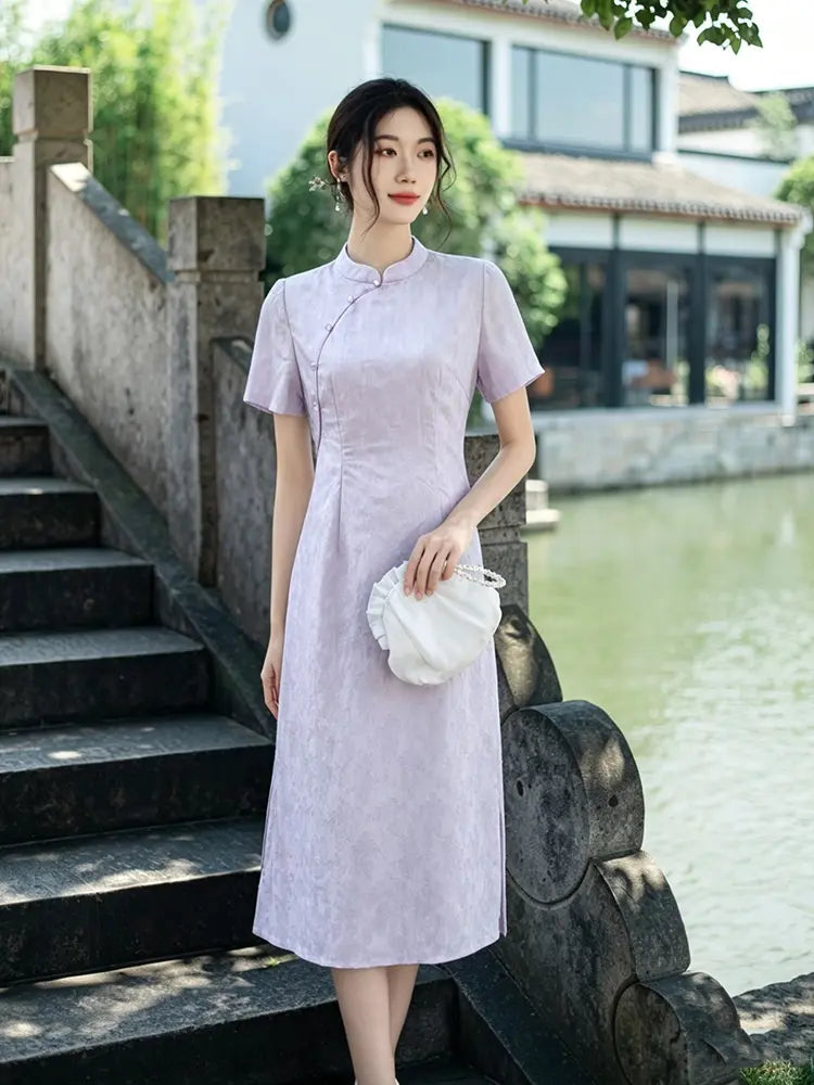 Woman in a light purple Modern Lavender A-line Short Sleeve Summer Qipao Dress standing by a traditional Chinese bridge over a river.