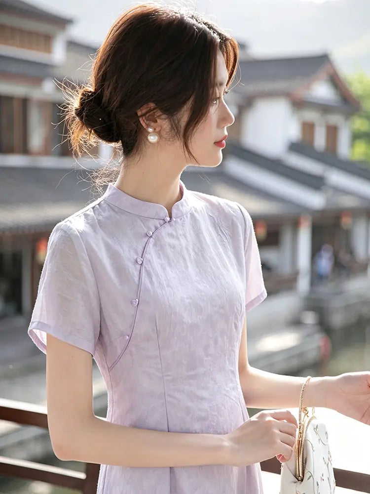 Woman wearing a light purple traditional Modern Lavender A-line Short Sleeve Summer Qipao Dress outfit with a blurred background