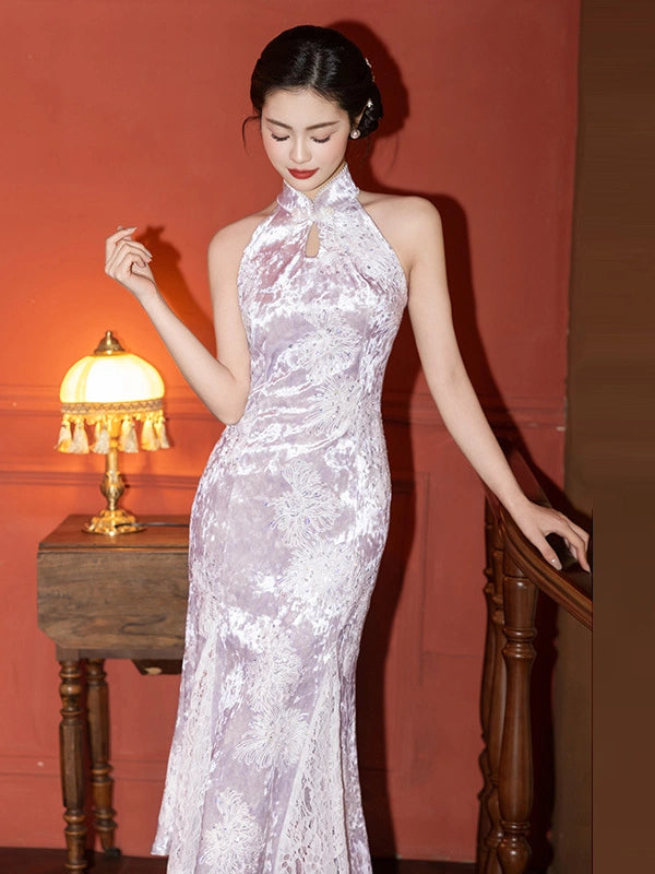 Woman in a elegant Modern Lavender Sequin Halter Neck Lace Mermaid Qipao cheongsam dress standing in a room with a lamp and wooden furniture.