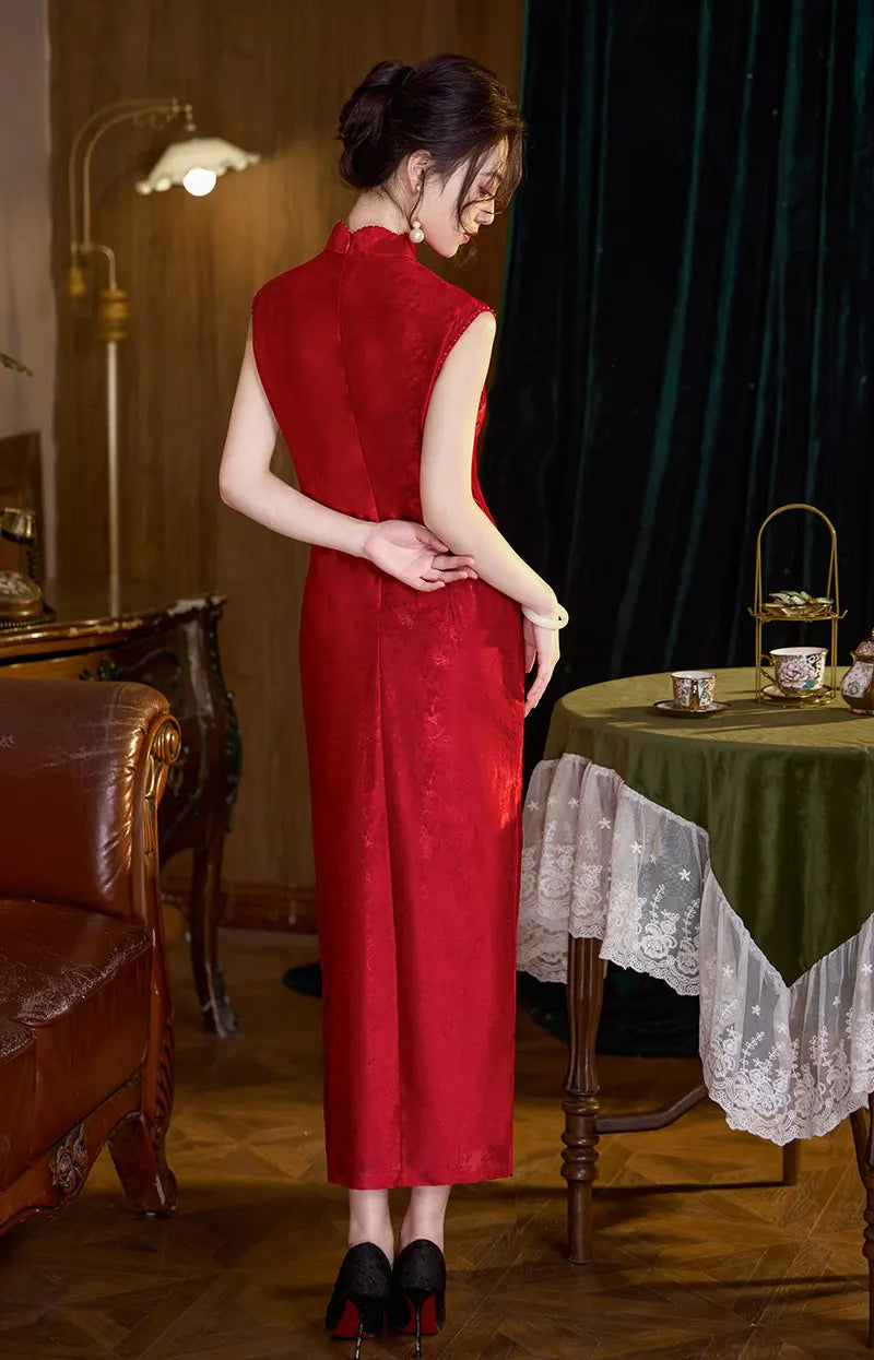 Woman in a Modern Red FLoral Jacquard Sleeveless wedding cheongsam Dress  standing in a room with a table and chair.