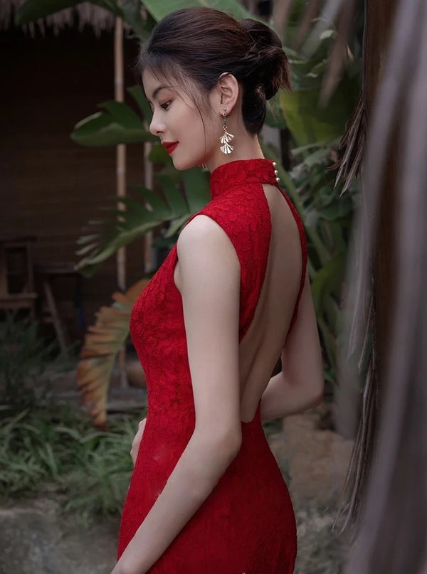 Woman in a Modern Red Lace Open-Back Qipao Cheongsam Dress standing outdoors with greenery in the background