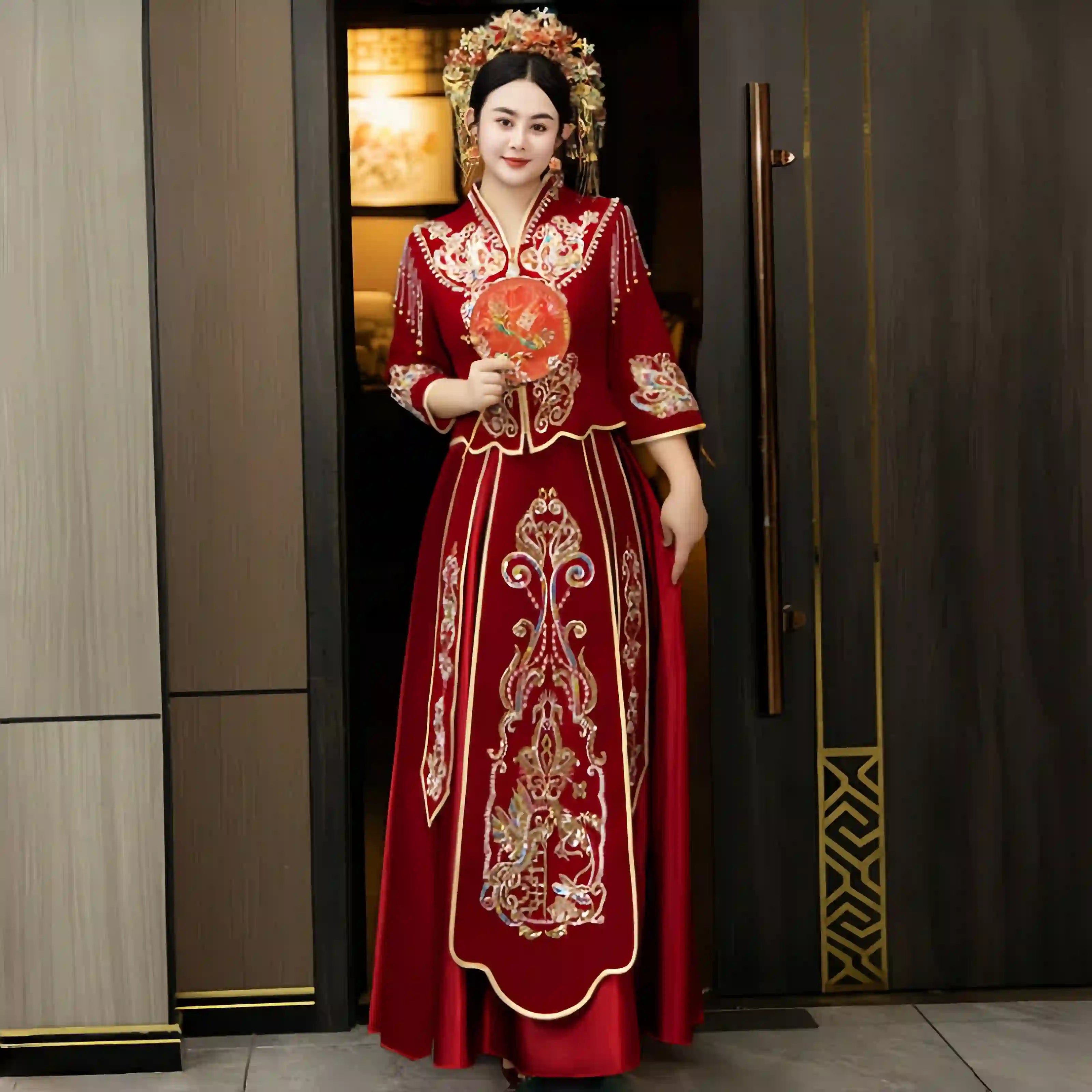 Woman in a  Modern Red Qun Kwa / Xiuhe Chinese Wedding Gown  standing in a doorway.