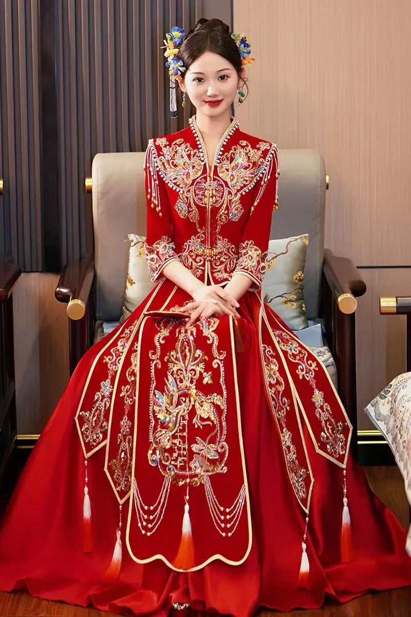 Woman in a traditional Modern Red Qun Kwa / Xiuhe Chinese Wedding Gown sitting on a chair.